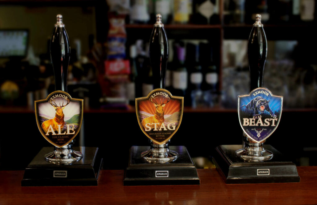 Ale pumps on a bar showing Exmoor Ale, Exmoor Stag, and Exmoor Beast