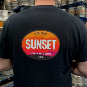 Back of the Sunset IPA T-shirt being worn by employee standing in a brewery.